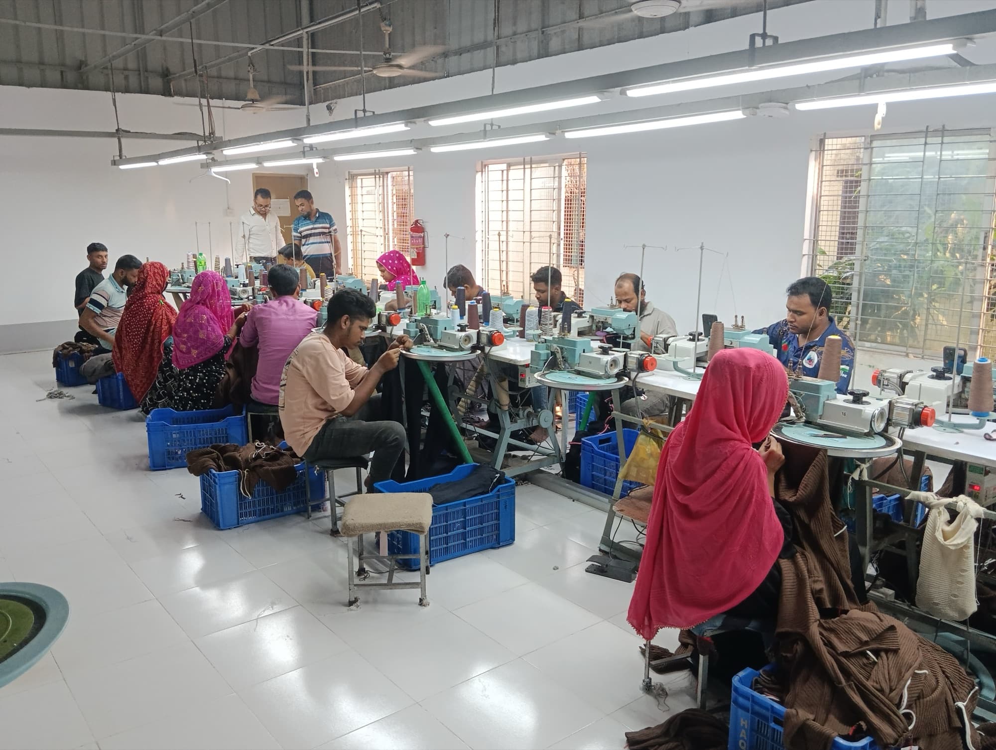 Rows of linking machines with operators at work