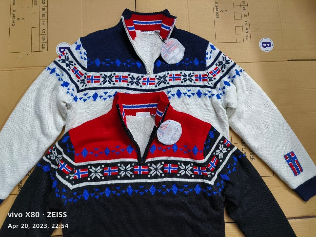 Two Nordic jacquard zip-neck sweaters with sherpa-lined collars